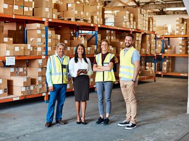 Four team members in a warehouse 