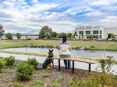 A woman and her dog looking at Tacoma Distribution Center A woman and her dog looking at Tacoma Distribution Center