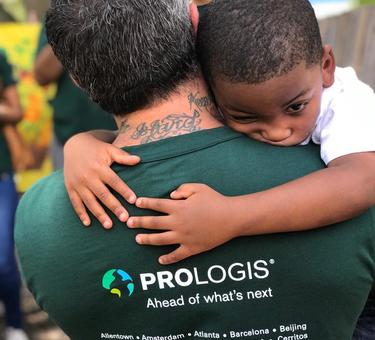 Young child hugging Prologis employee participating in IMPACT Day 2019